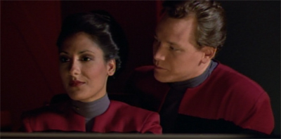 He Stadis her closely...