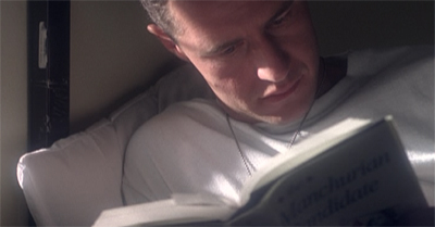 Of course he's reading The Manchurian Candidate...