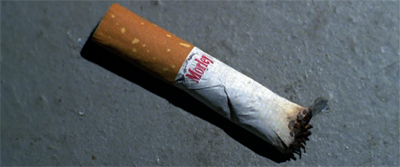 A smoking cigarette stub...