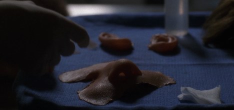 Taking his face... off.